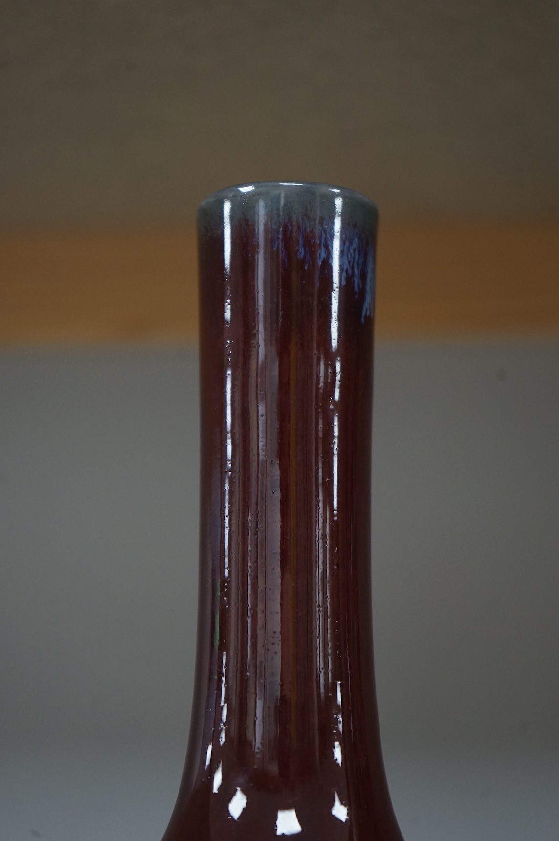 Two Chinese Sang de Boeuf glazed vases to include a bottle neck example, largest 27cm high